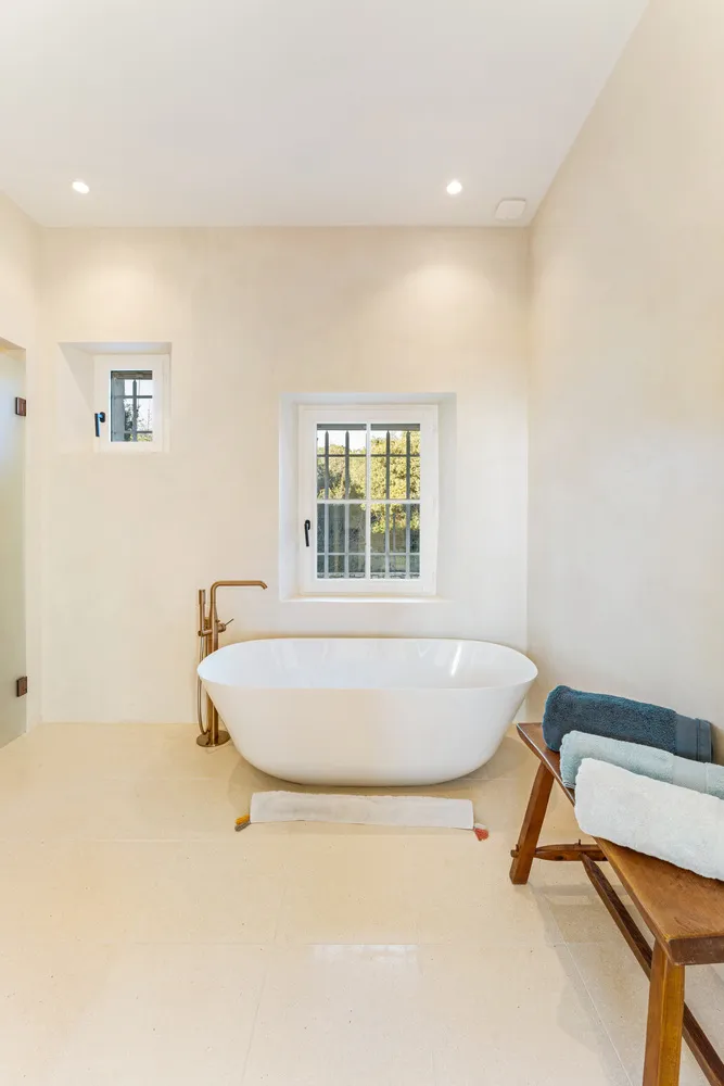 En-suite bathroom with a freestanding bath and brass fittings