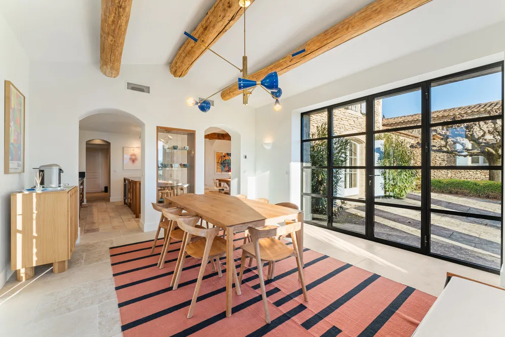 Dining room with steel-framed doors opening to the terrace