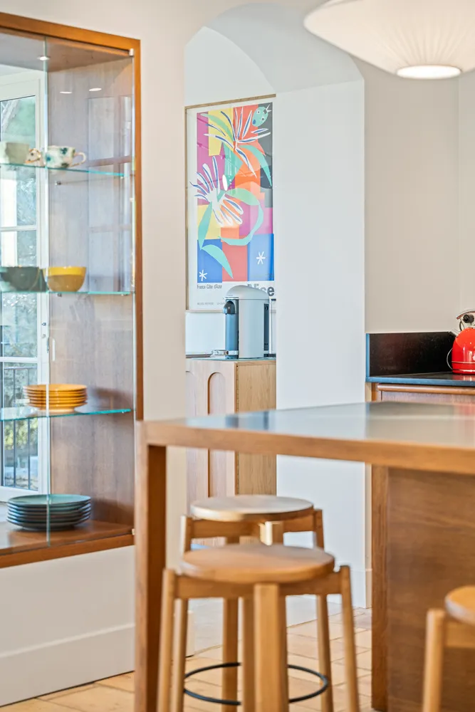 Oak stools at the island, glazed cabinet and coffee machine